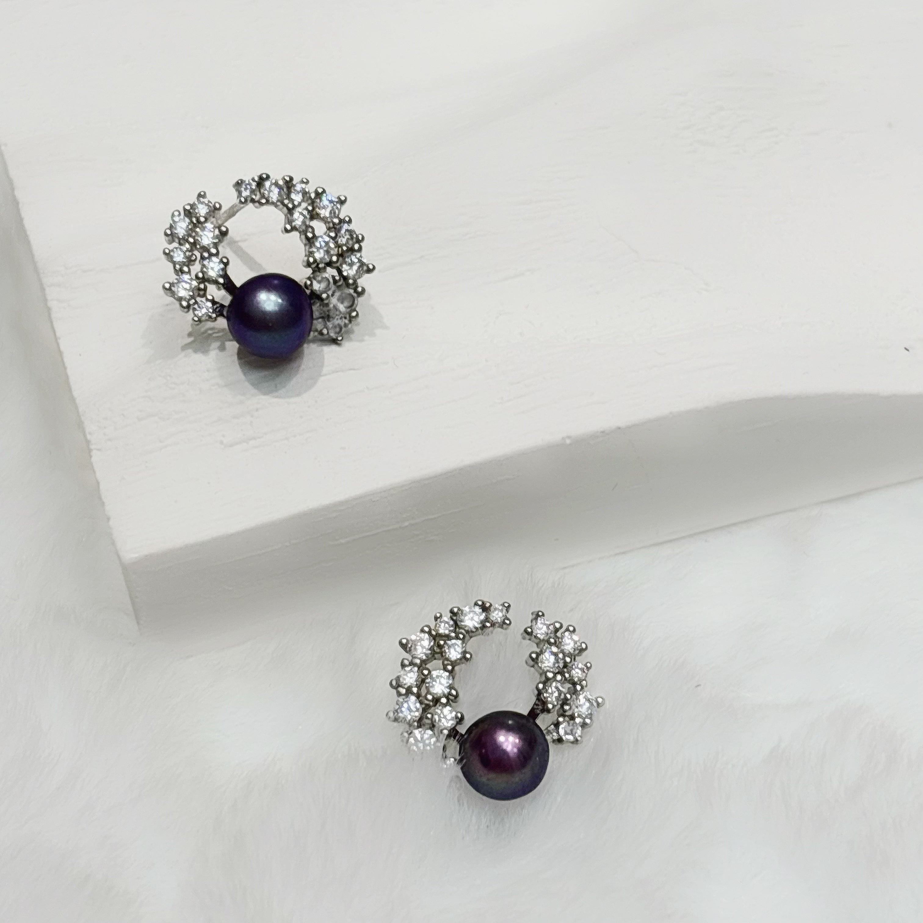 Minimalist Serene Earrings with a purple bead surrounded by a silver crystal halo
